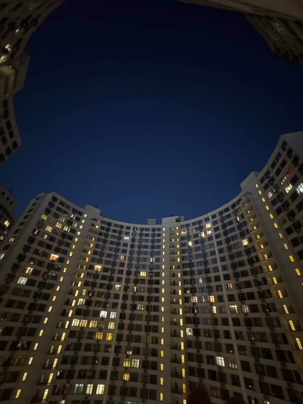 Odesa residential complex glows at night, courtyard fountain visible