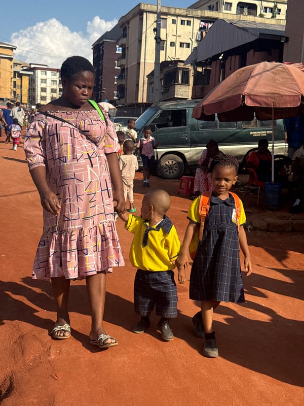 School kids fill Onitsha streets on a busy afternoon