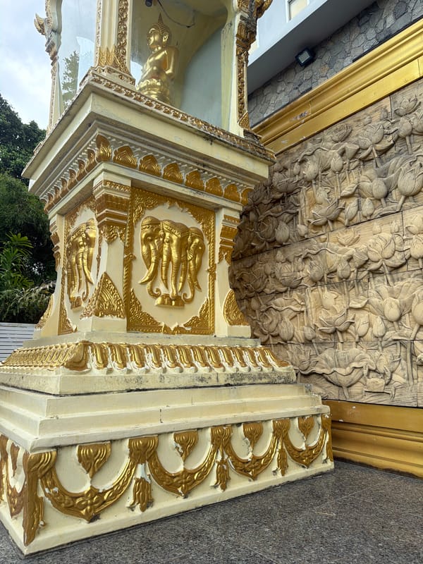 Exploring a Thai temple complex with shrines, offerings, and parking lot scenes