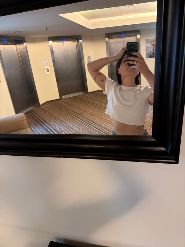 Mirror selfie in a Khimki hotel hallway near elevator bank