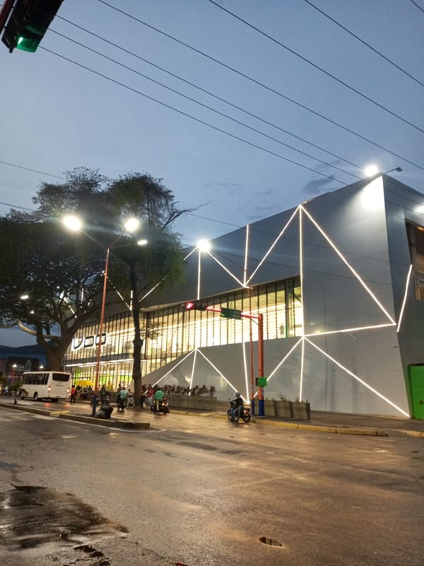 Wet streets reflect twilight lights in Valencia, Venezuela