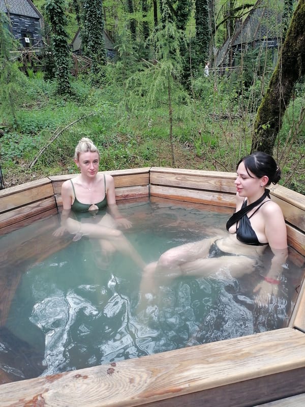Families enjoy outdoor hot tub facilities in wooded Medoveevka