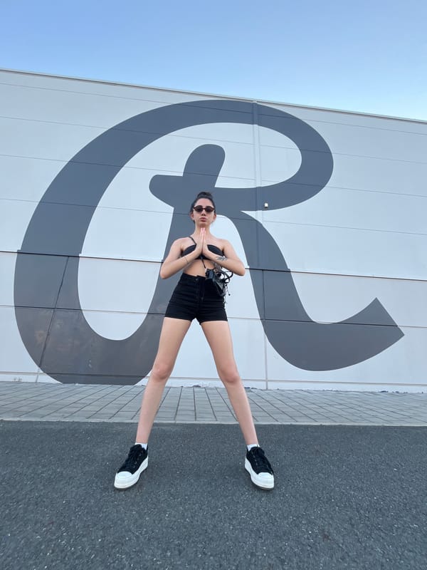 Posing and playing around a bold 'R' mural in Pilsen