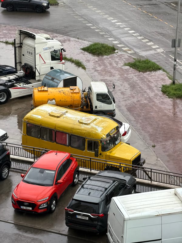 Woman takes indoor selfies during rainy afternoon in Tbilisi