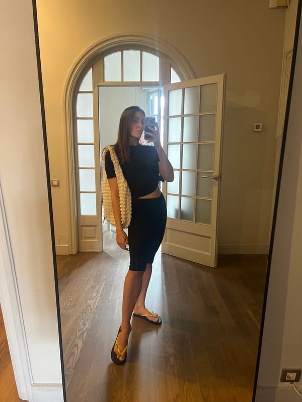Woman takes mirror selfie in Barcelona hallway
