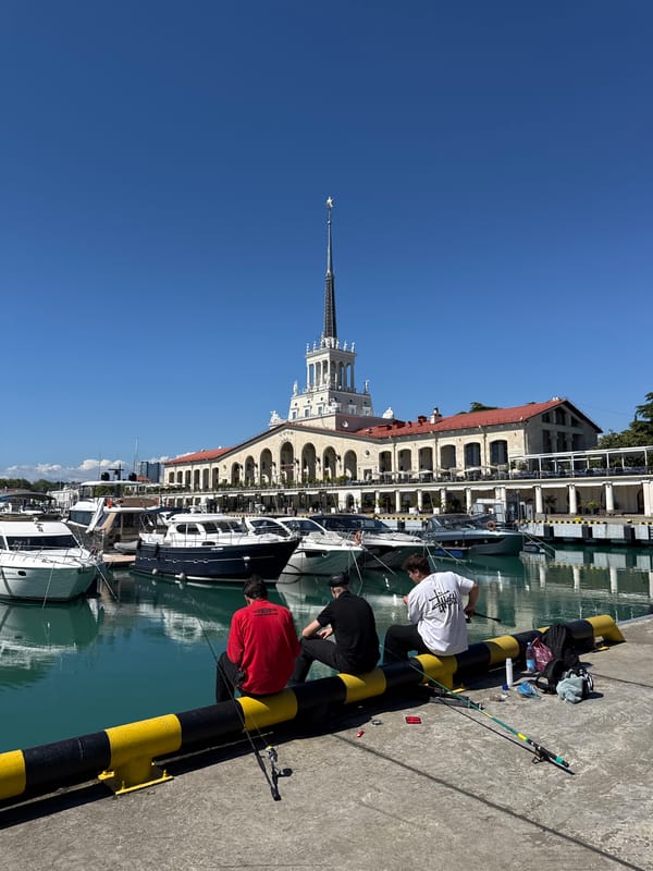 Fishing and leisure activity at Sochi marina on sunny afternoon