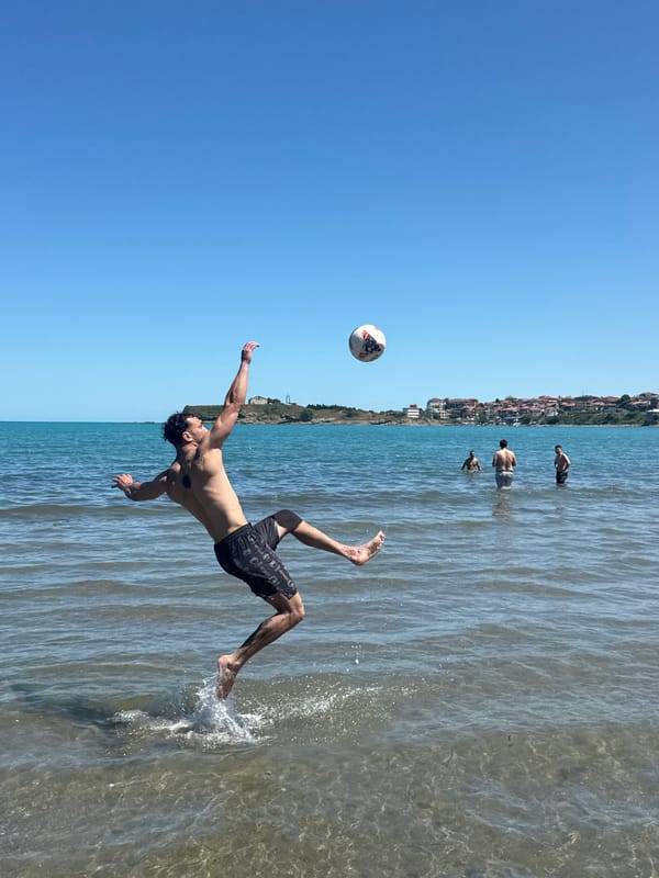 Man plays soccer in ocean waters at Bulgarian beach