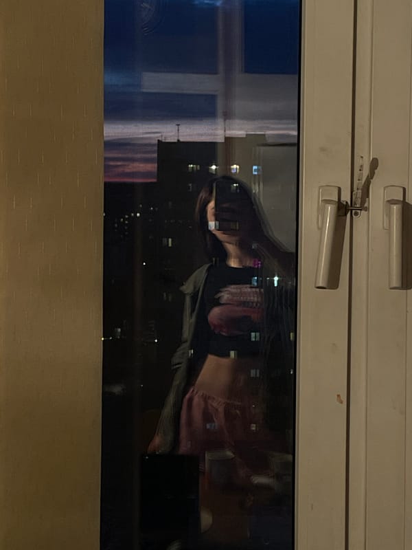 Person photographs window reflections in Moscow indoor setting