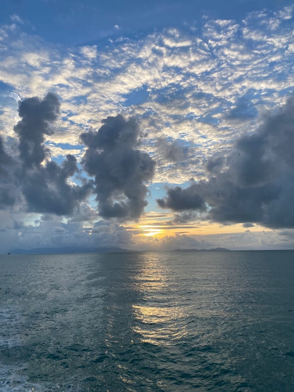 Ferry passenger enjoys sunset view near Don Sak, Thailand