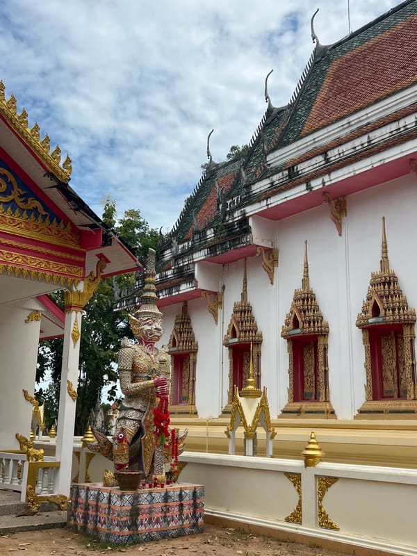 Inside and outside a Ko Samui temple with guardian statues