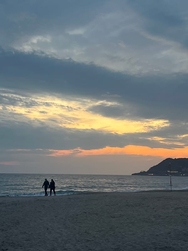 Two people enjoy sunset at Alanya beach