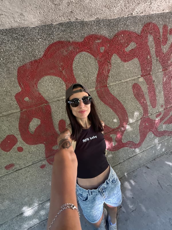 Woman in '90s baby' shirt photographed on Pleven street