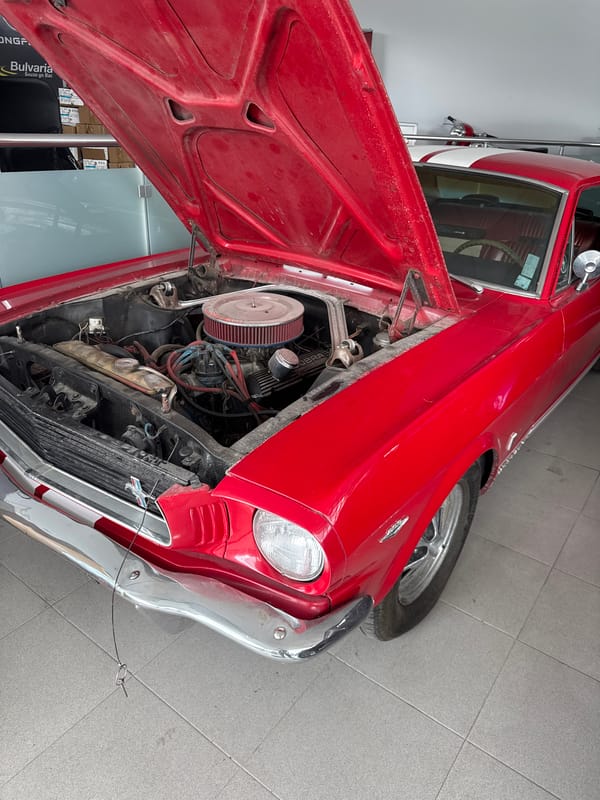 Vintage red car displayed with hood open in Varna museum