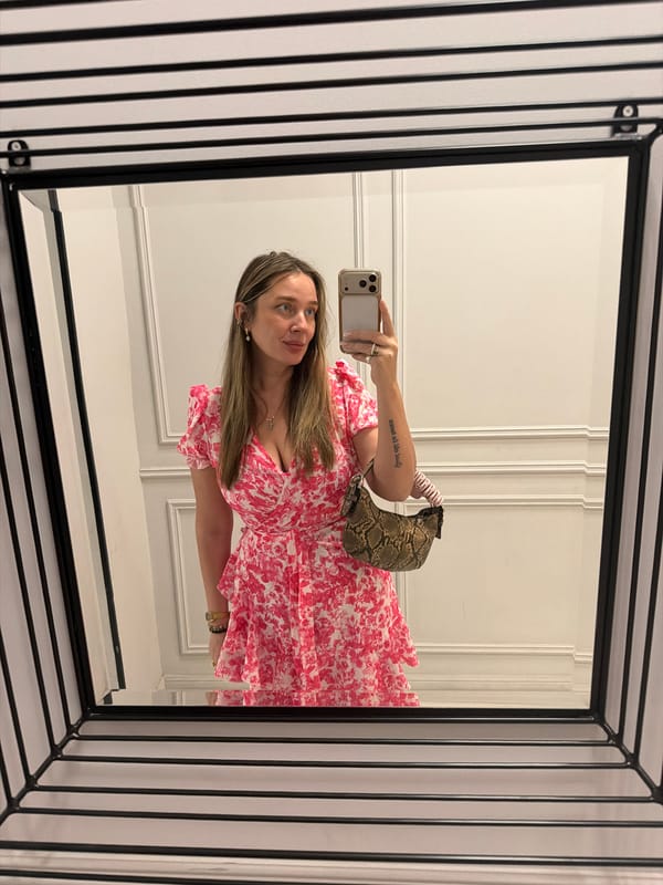 Woman takes selfie in mirror wearing floral dress, Moscow