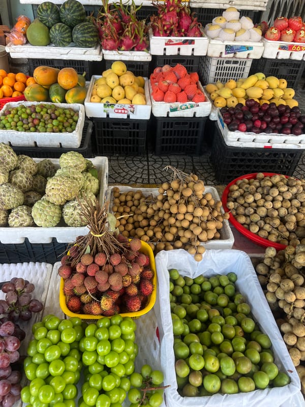 Fresh fruit stalls and vendors at a Da Nang street market