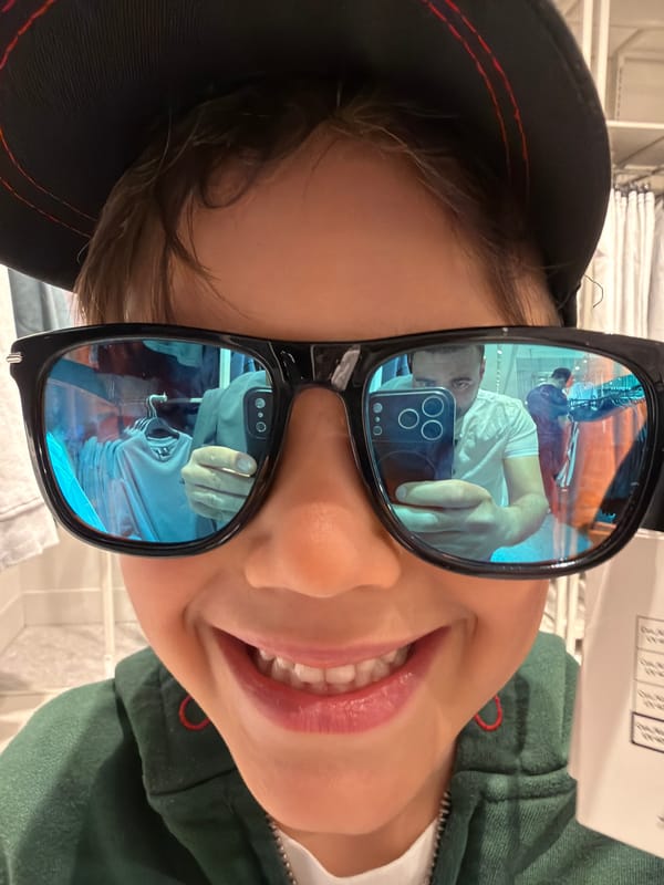 Family visits Hamleys toy store in London, views dinosaur display