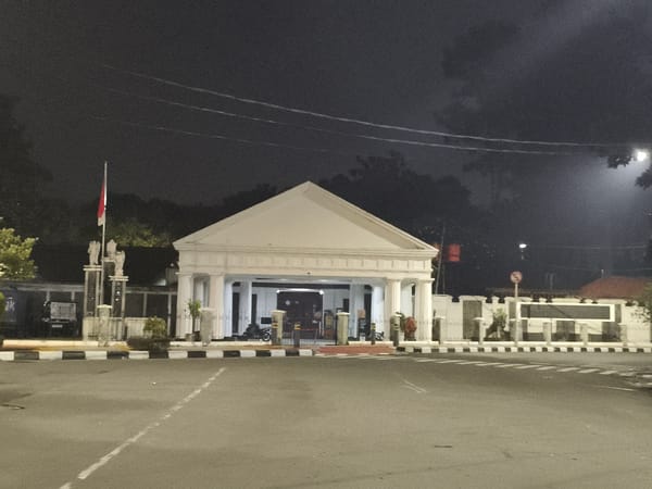 Classical white building documented at night in Central Jakarta