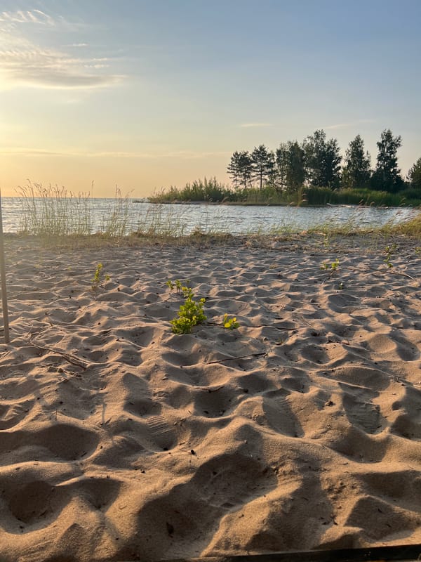 Sunset along a quiet Borovoe beach with an inflatable boat