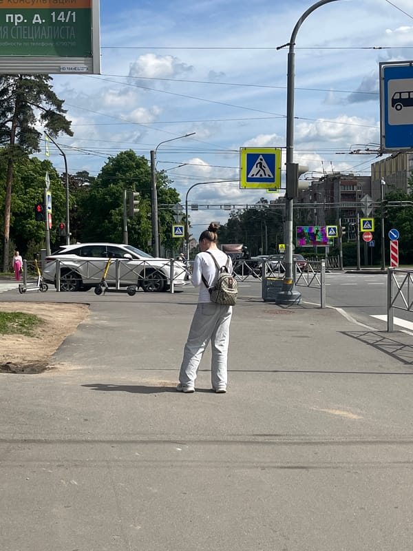 Woman spotted standing roadside in Saint Petersburg street scene