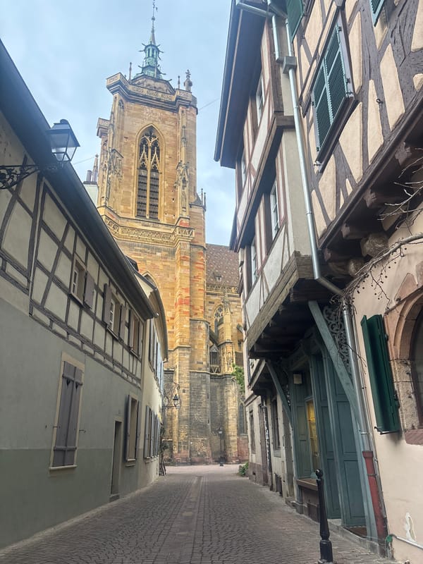 Tourist documents medieval architecture in Colmar's historic quarter