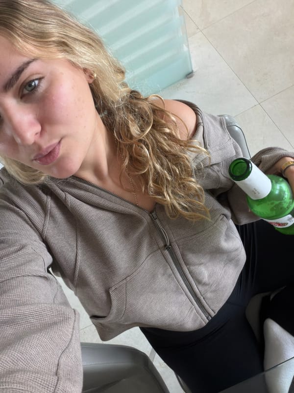 Woman with green bottle photographed indoors in Key Biscayne