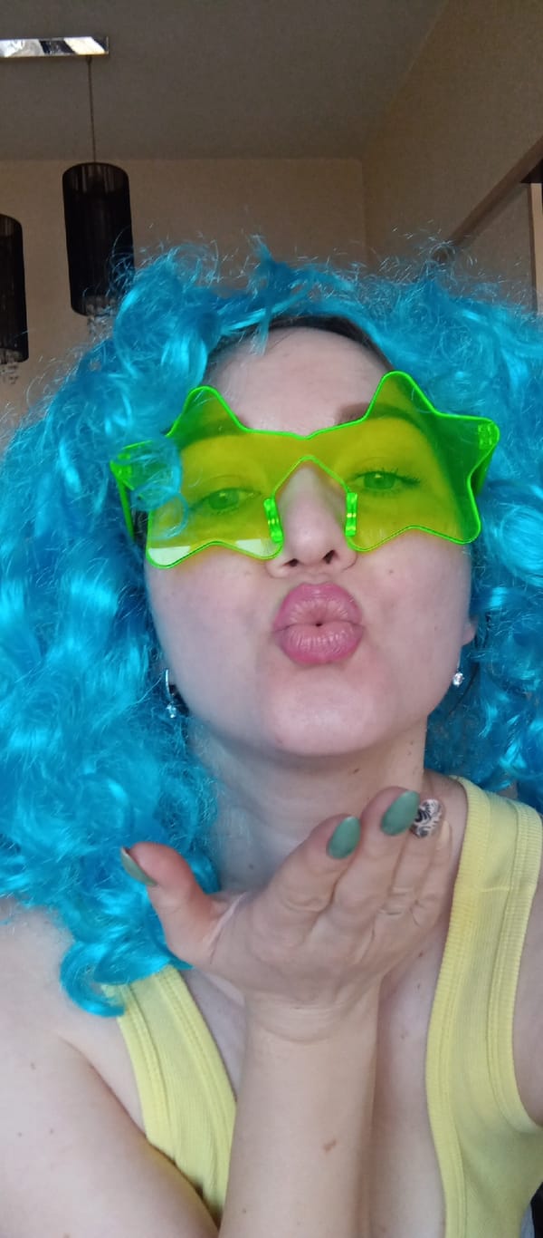 Person in colorful costume poses indoors with coin collection