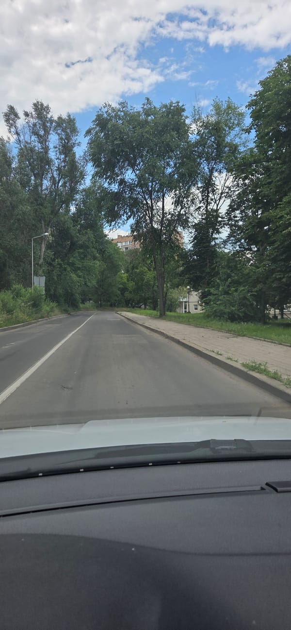 Street-level drive through Donetsk under overcast skies
