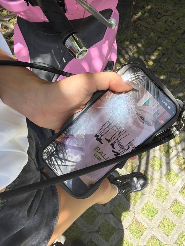 Smartphone displays Bali night club advertisement in Canggu
