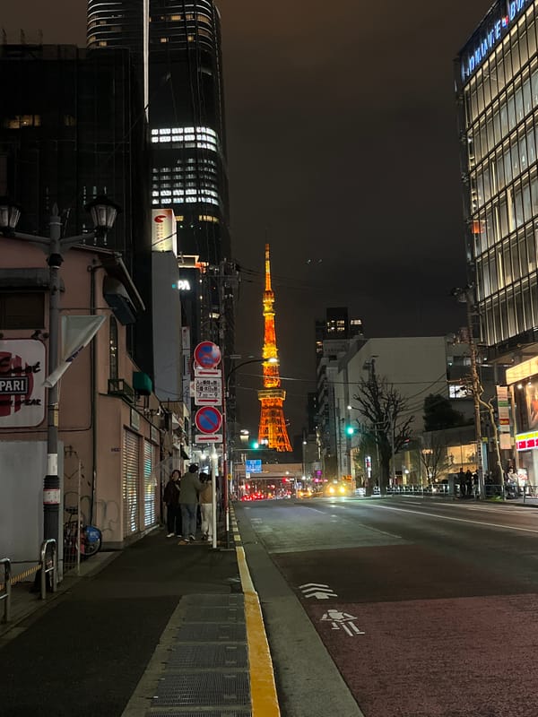 Tokyo Tower glows orange in nighttime Minato City scene