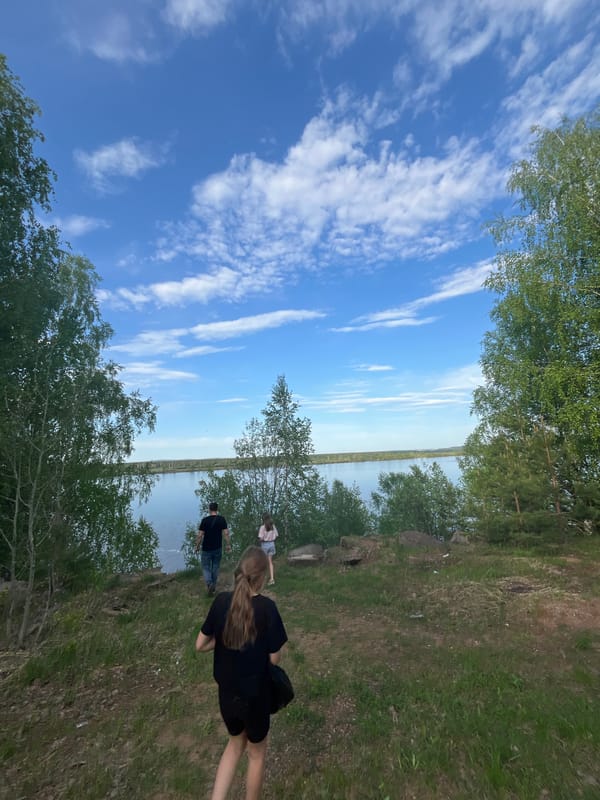 Woman takes selfies at canal waterway in Chernushka, Russia