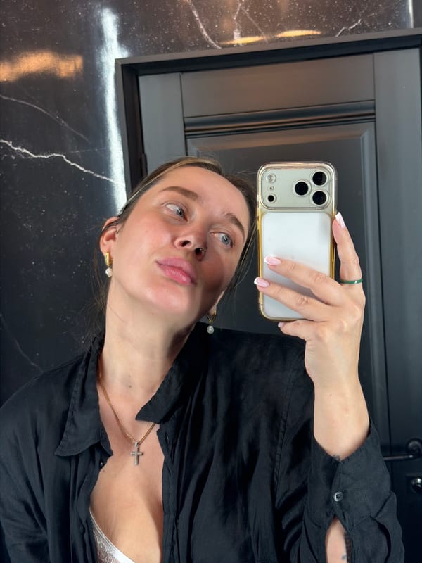 Woman takes selfie against marble wall in Podolsk