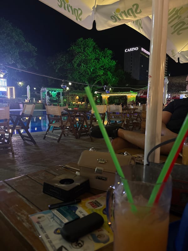 Poolside bar gathering with drinks and colorful straws