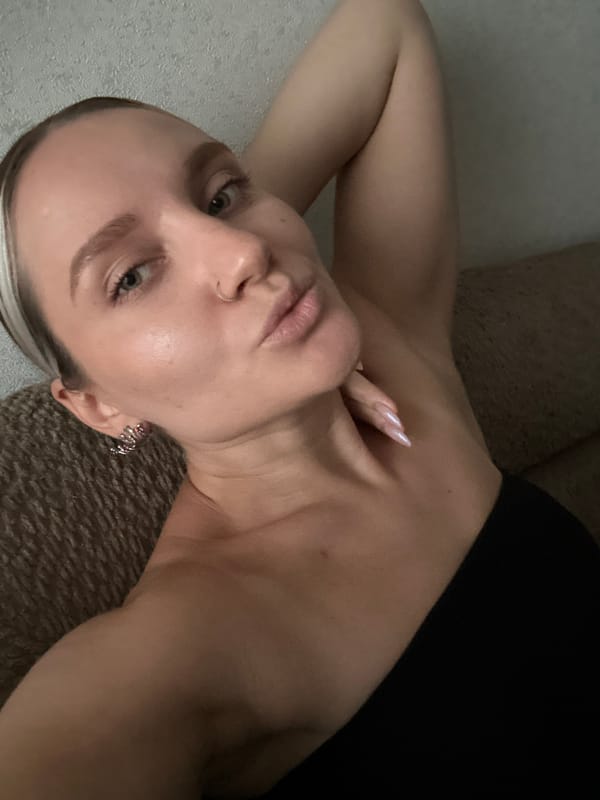 Woman poses casually on couch in Esenyurt apartment