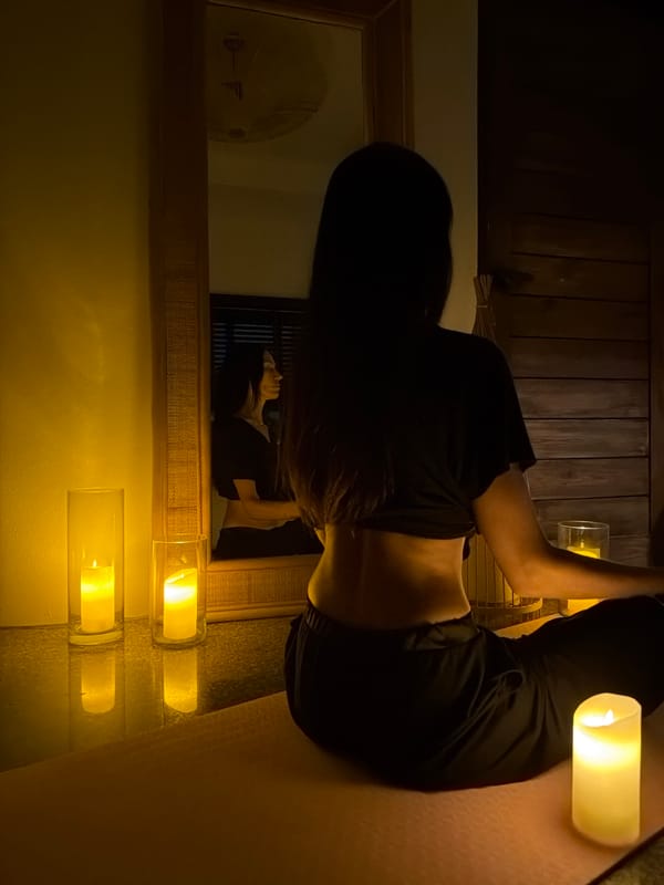 Candlelit meditation session in a dim Ko Samui room