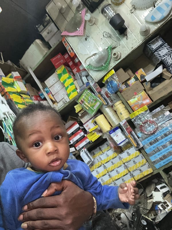 Family visits electronics shop in Narayi, Nigeria