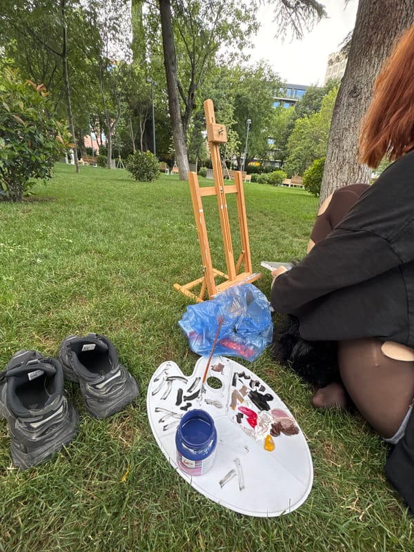 Red-haired artist paints anime portrait in Tbilisi park
