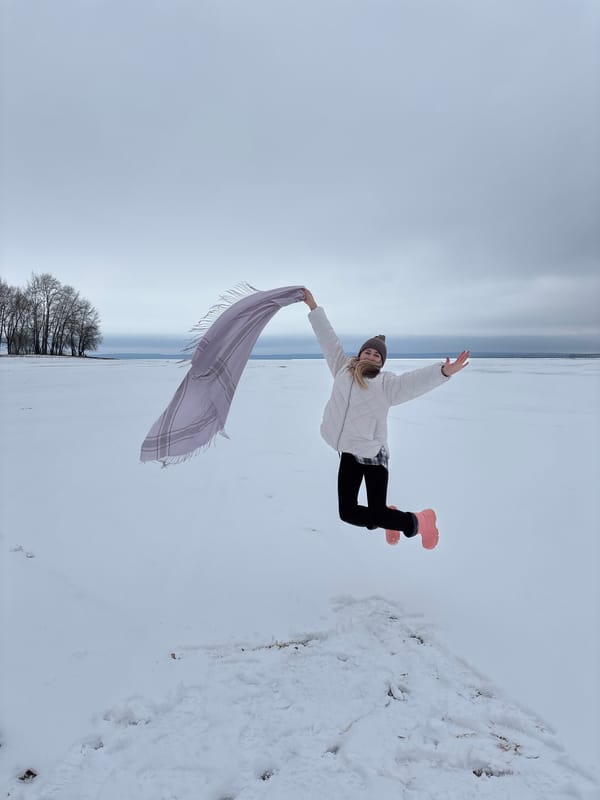 Person poses with scarf in snowy Chaikovsky landscape