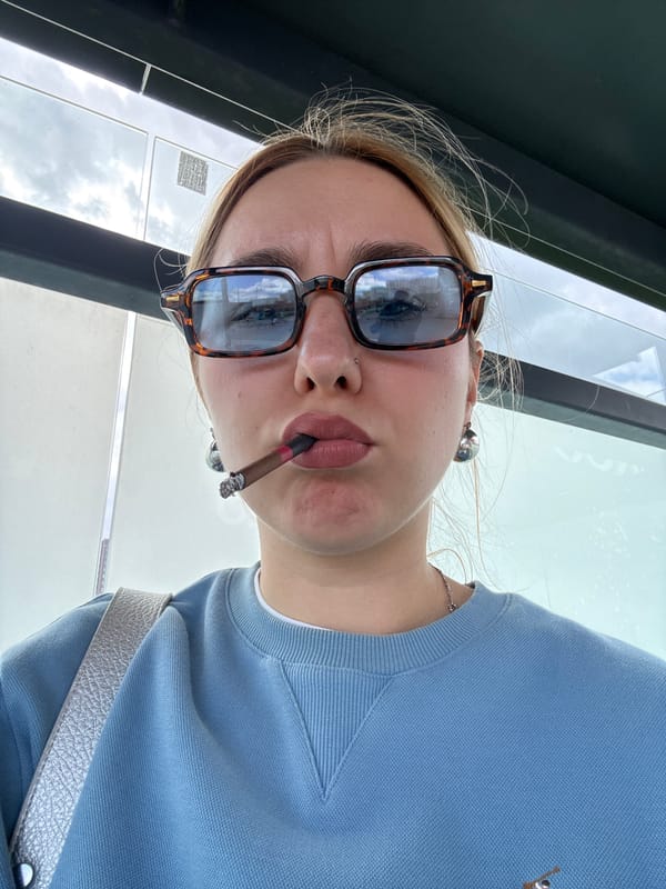 Woman smoking at possible bus stop in Minsk