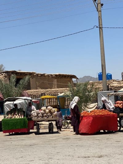 Morning street vendors operate fruit carts in Kandahar
