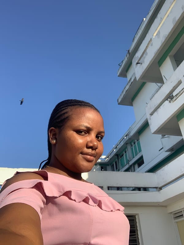 Woman photographed smiling under clear sky in Dar es Salaam