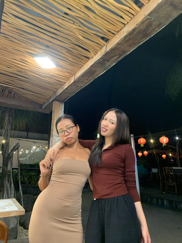 Two women photograph together at North Kuta restaurant venue