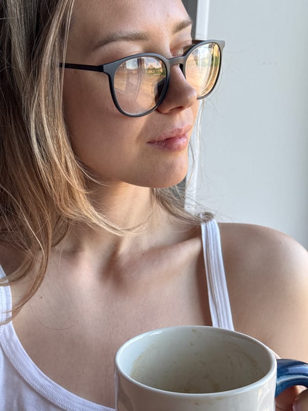Woman with coffee mug photographed indoors in Chaikovsky