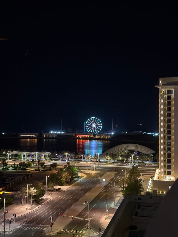 Colorful Ferris wheel lights over Lusail's waterfront at night