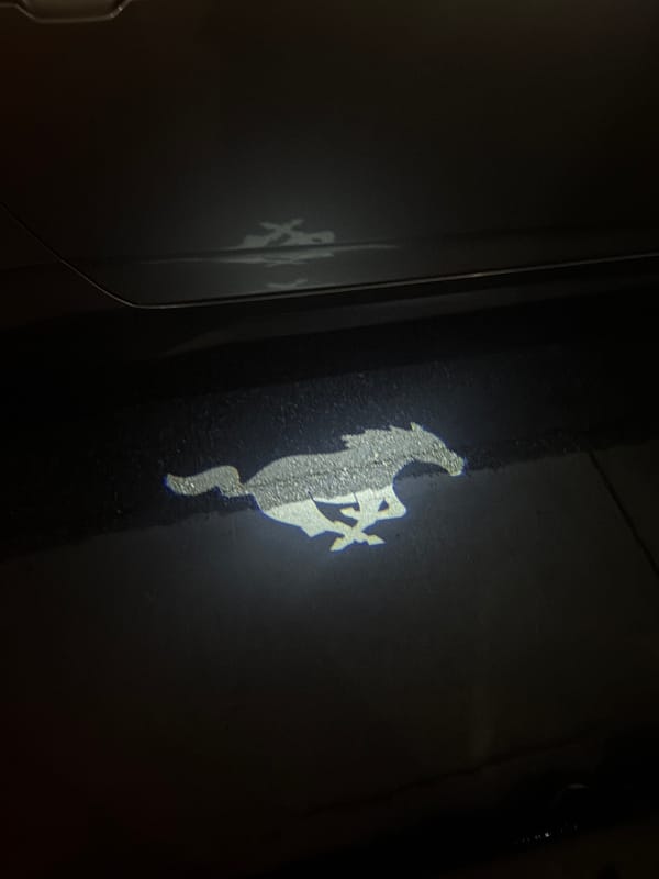 Ferrari logo projected onto dark surface in Palm Desert