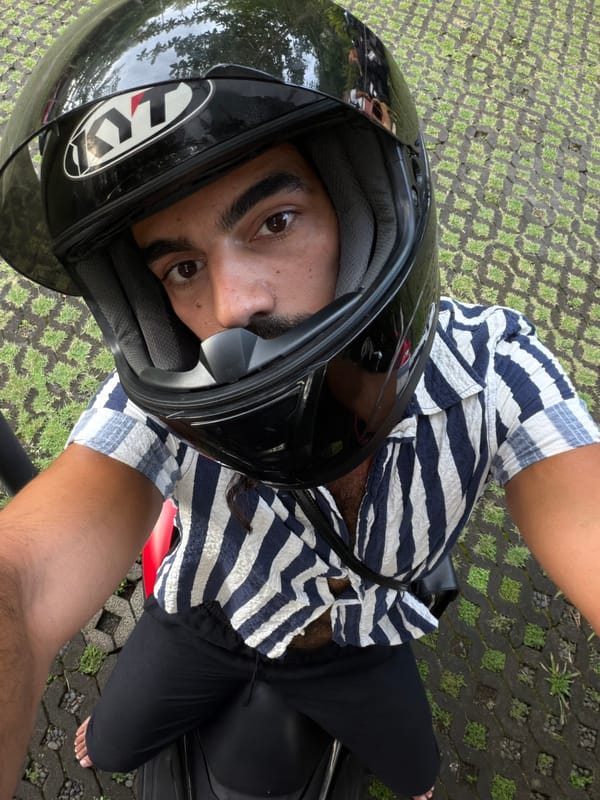 Motorcyclist Takes Selfie on Red Bike in Sukawati