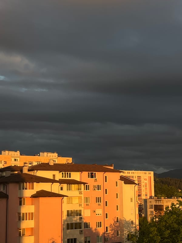 Stormy skies create pink lighting over Gabrovo apartments