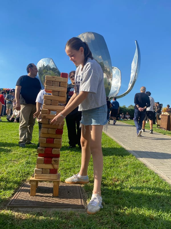 Woman plays giant Jenga outdoors in Buenos Aires