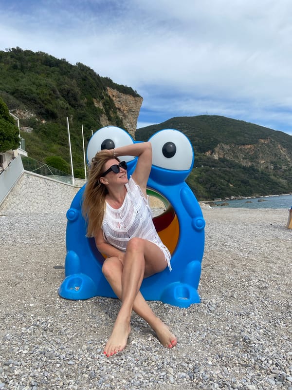 Woman poses on coastal rocks near Prijevor, Montenegro