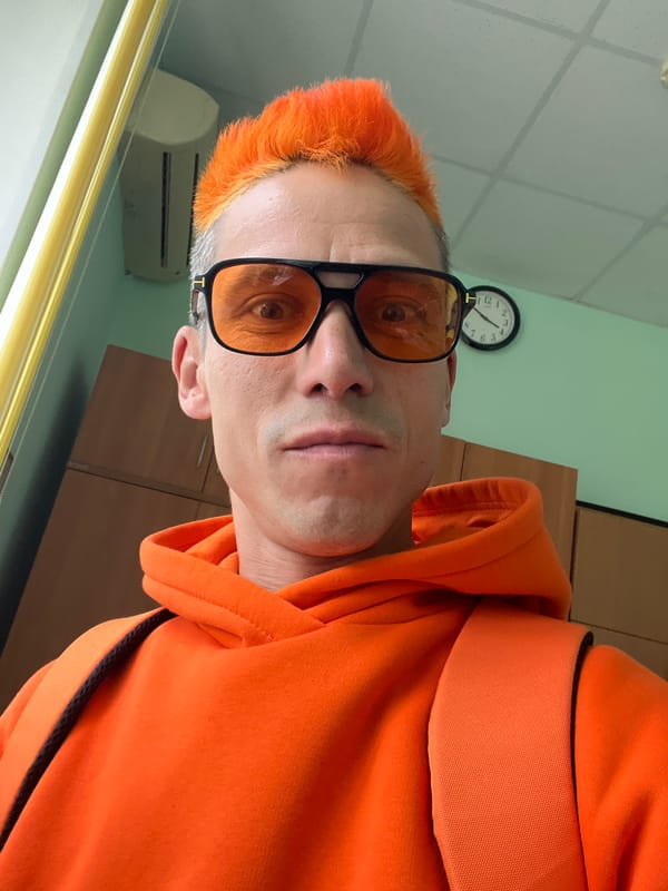 Orange-haired man takes selfies in Chaikovsky, Russia apartment