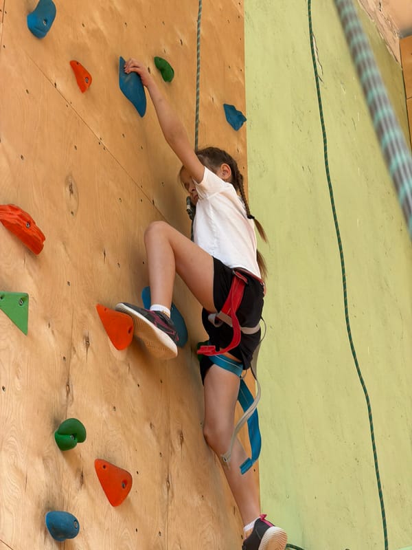 Young climbers practice on indoor rock wall in Izhevsk